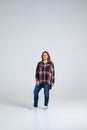 Smiling woman in loose shirt posing at studio