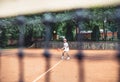 Full length shot of a sporty little girl on open tennis court. Child girl athlete playing tennis in the sport club. Active Royalty Free Stock Photo