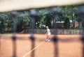 Full length shot of a sporty little girl on open tennis court. Child girl athlete playing tennis in the sport club. Active Royalty Free Stock Photo