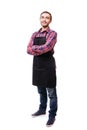 Full length shot of young chef or waiter posing, wearing black apron and shirt isolated on white background Royalty Free Stock Photo