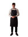 Full length shot of young chef or waiter posing, wearing black apron and white shirt Royalty Free Stock Photo