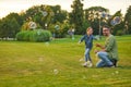 Full length shot of young father and his cute little girl having fun while blowing soap bubbles on a summer day Royalty Free Stock Photo