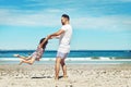 Flying with her father. Full length shot of a young father and his daughter enjoying a day at the beach.