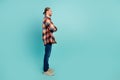 Full length side profile photo of cool guy wear flannel shirt hold arms folded look at offer empty space isolated on Royalty Free Stock Photo