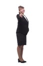 Full length, side view of a confident young business woman standing with folded hands Royalty Free Stock Photo