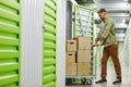 Man Moving Boxes in Storage Unit Royalty Free Stock Photo