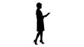 Silhouette Young woman engineer walking with tablet looking at objects around. Royalty Free Stock Photo