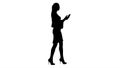 Silhouette Young woman walking with shopping bags talking on mob Royalty Free Stock Photo