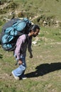 Full length side view of a young man walking in the mountain with carrying parachute backpack Royalty Free Stock Photo