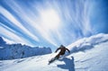 Full length of skier skiing on fresh powder snow Royalty Free Stock Photo