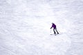 Full length of skier skiing on fresh powder snow. Man skier running downhill on sunny Alps slope