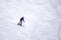 Full length of skier skiing on fresh powder snow. Man skier running downhill on sunny Alps slope