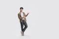 Full length smart young Asian man happy smile standing hand pointing to empty space on white background Royalty Free Stock Photo