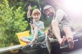 Full length of smiling father and son catching fish in butterfly fishing net Royalty Free Stock Photo