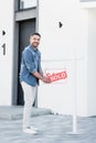 Young bearded man holding sign with Royalty Free Stock Photo