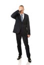 Full length stressed businessman covering his face Royalty Free Stock Photo