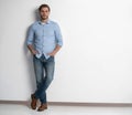 Full length studio portrait of casual young man in jeans and shirt. Isolated on white background. Royalty Free Stock Photo
