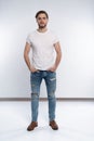 Full length studio portrait of casual young man in jeans and shirt. Isolated on white background. Royalty Free Stock Photo