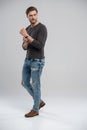Full length studio portrait of casual young man in jeans and shirt. Isolated on white background. Royalty Free Stock Photo