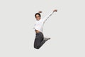 Full length overjoyed African girl jumping isolated on grey background