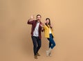 Full length of stylish young couple showing OK Okay signs and screaming ecstatically while looking at camera. Excited man and Royalty Free Stock Photo