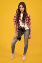 Full length of teenager girl with dslr professional photo camera with big photo lens. Child photographer isoalted on Royalty Free Stock Photo
