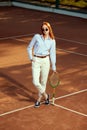 Full-length top view image of beautiful redhead young woman in stylish casual clothes and sunglasses posing on opendoor Royalty Free Stock Photo