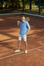 Full-length top view image of handsome redhead young man in stylish casual clothes and glasses posing on opendoor tennis Royalty Free Stock Photo