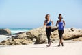 Full length two young women running on the beach Royalty Free Stock Photo