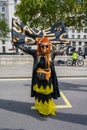 Full length vertical shot of Extinction Rebellion Protester holding a Save Bees banner at an Extinction Rebellion Protest March