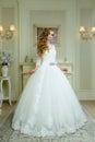 Full length view on beautiful woman posing in a wedding dress. Royalty Free Stock Photo