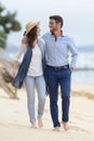 Full length view couple walking along beach Royalty Free Stock Photo