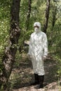 Full length view of ecologist in protective costume and respirator