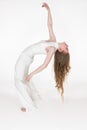 Full length view of flexible young woman dancer bending over backwards with eyes closed. Side view Royalty Free Stock Photo