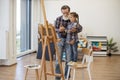 Child enjoying art making with grandpa in home studio