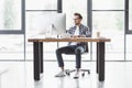 full length view of handsome young programmer using desktop computer Royalty Free Stock Photo