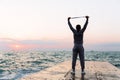 Full length view of sportsman stretching with jump rope, on pier Royalty Free Stock Photo