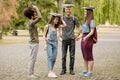 Full length view on students walking in campus, fooling around. Royalty Free Stock Photo