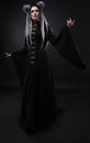 Full length view of woman with dreads wearing black gothic coat