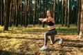 Sportive girl stretching exercises outdoors
