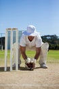 Full length of wicketkeeper holding ball behind stumps Royalty Free Stock Photo