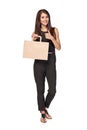 Full length woman holding carton brown shopping bag