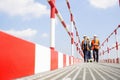 Full-length of workers walking on footbridge against sky Royalty Free Stock Photo