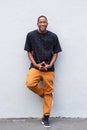 Full length young african man standing against gray wall Royalty Free Stock Photo