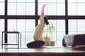 Full-length of young calm sporty pregnant woman doing yoga online at home, looking at digital table screen and doing stretching Royalty Free Stock Photo