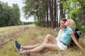 Full length of young hiking couple relaxing in forest