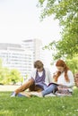 Full length of young male and female friends studying at college campus Royalty Free Stock Photo