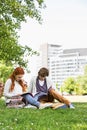 Full length of young male and female friends studying at college campus Royalty Free Stock Photo