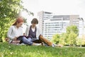 Full length of young male and female friends studying at college campus Royalty Free Stock Photo