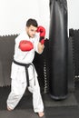 Full length of young man in kimono throwing punches Royalty Free Stock Photo